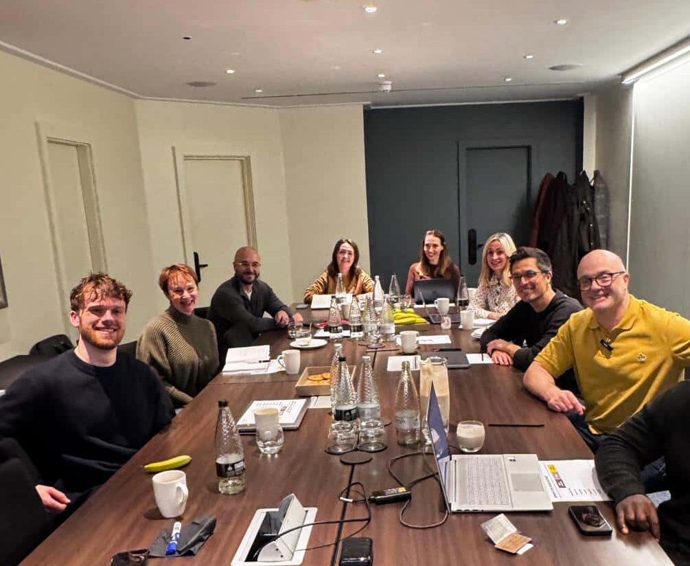 Agency founders around a boardroom table during an AI consultancy workshop.