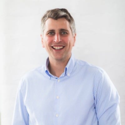 Profile image of James Starkey in a blue striped shirt on a pale background