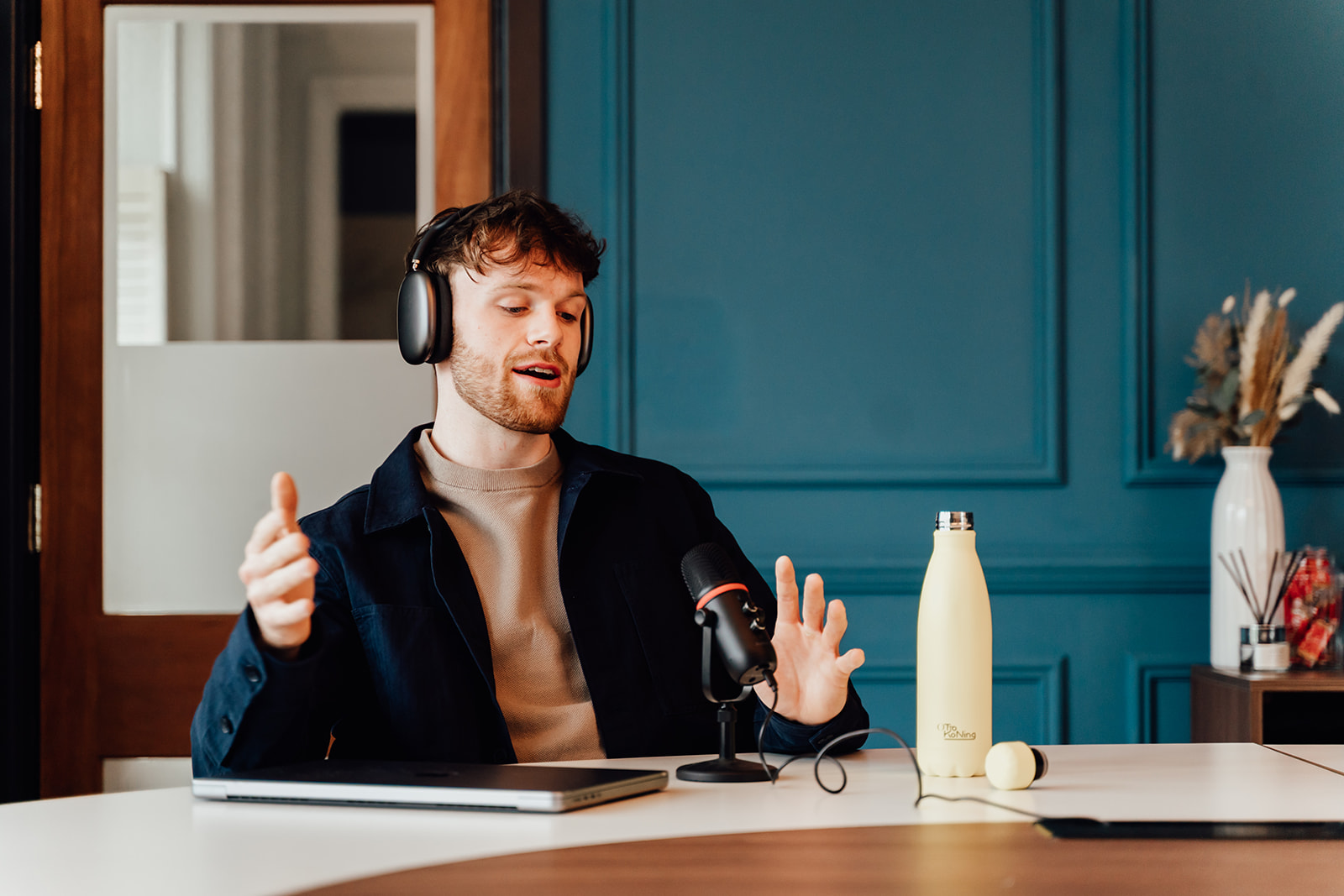 Callum Healey speaking with headphones and a microphone.