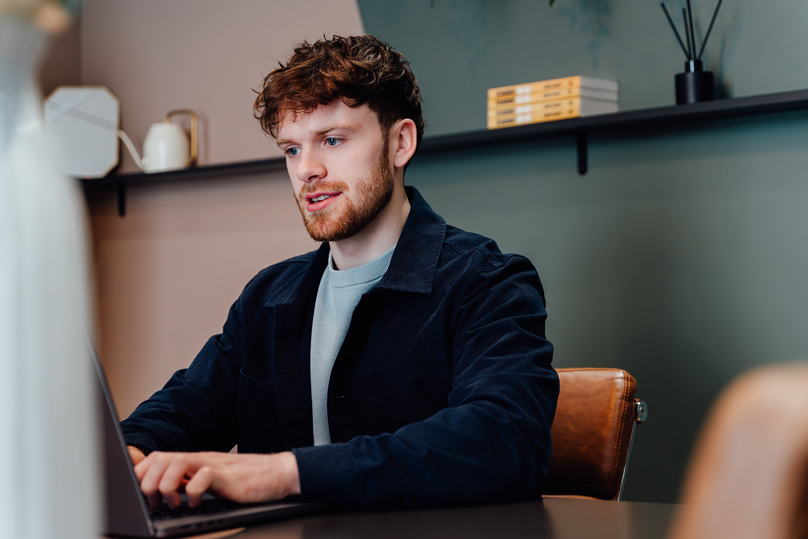 Callum Healey, AI consultant, working at his desk.