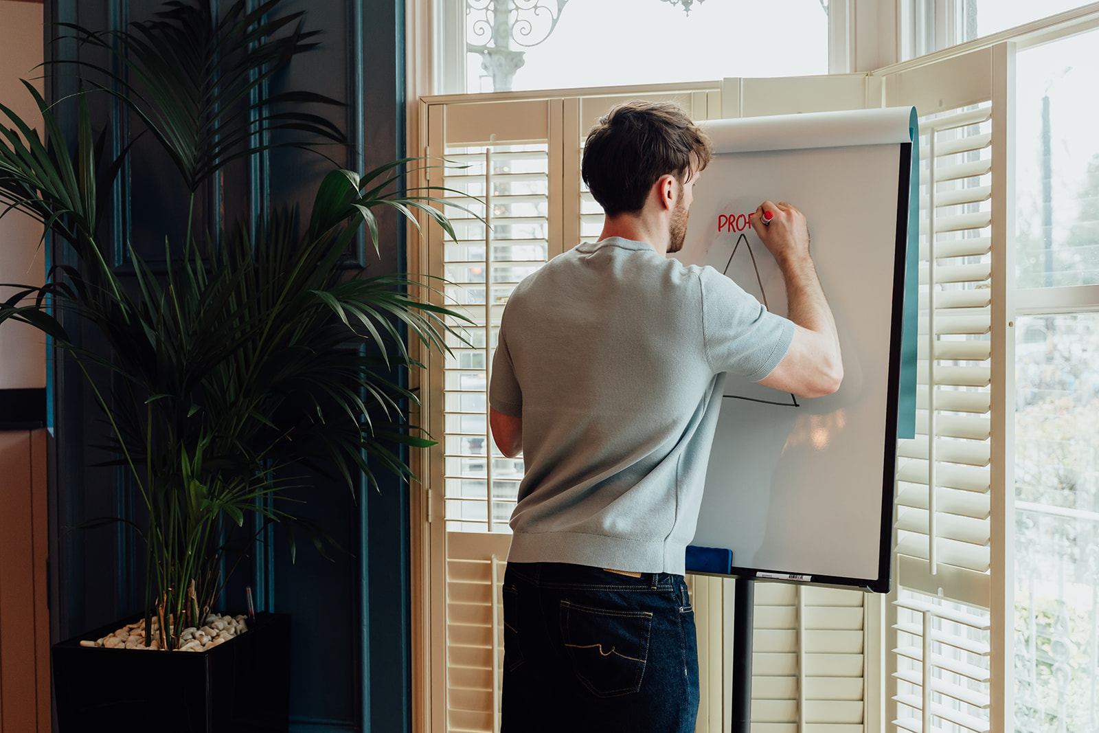 Callum Healey writing on a whiteboard.